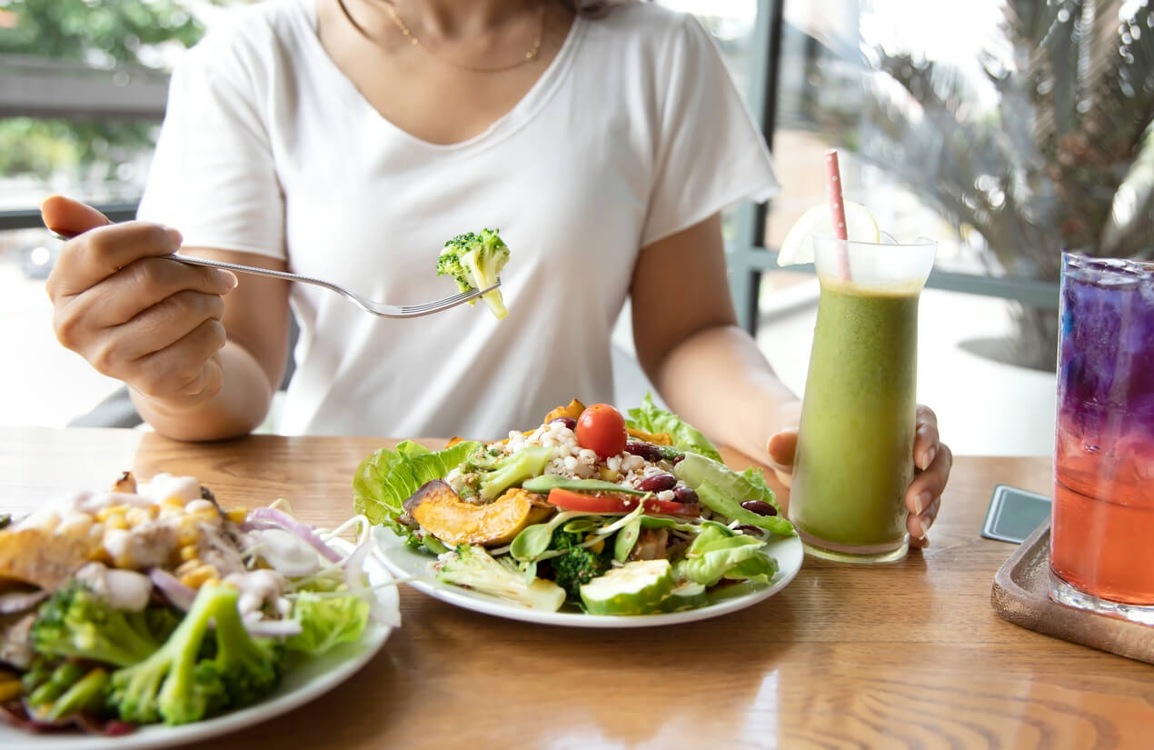 Selective focus of woman with Broccoli and salad which she make a Intermittent fasting with a Healthy food of salad and detox drink,